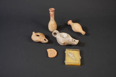 several small pieces of pottery sitting on top of a black surface