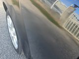 a black car that is parked on the side of the road