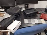 a cluttered desk with two computer monitors and a laptop