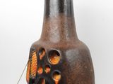 a brown vase with an orange design on it