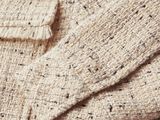 a close up of a sweater with a button on it