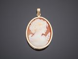 a gold and cameo cameo pendant with a woman ' s profile