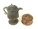 a small teapot and a small teapot on a white surface