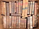 a box full of old books sitting on the floor