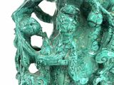 turquoise green sculpture of a dragon on a rock on a white background