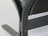 black leather lounge chair with metal frame and foot rest