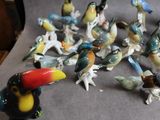 many figurines of birds that are sitting on a table