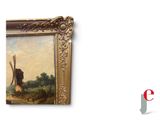 a picture of a painting of a windmill on the wall