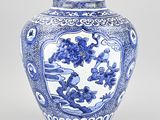 blue and white vase with flowers and birds on it on a white background
