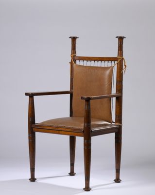 une image représentant une chaise avec une assise en cuir et des pieds en bois