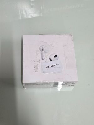 a white box with an earphone in it on a table