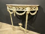 an antique console table with a marble top and ornate carvings