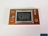 a small electronic game on a white table