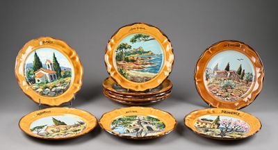 several plates with a picture of a village and a church on them