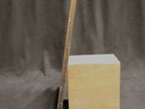 a picture of a piece of wood with a ruler sticking out of it