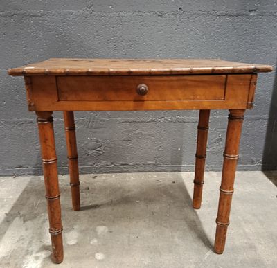an old wooden table with a drawer on top of it
