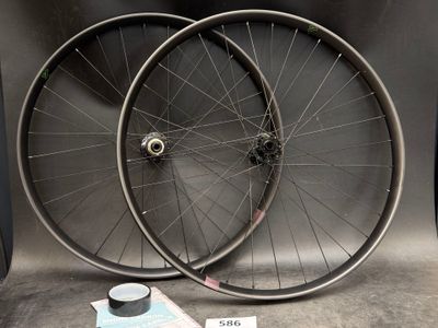 two bicycle wheels sitting next to each other on a table