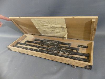 an image of a wooden box with a set of rulers in it