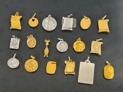 many different types of gold and silver charms on a table