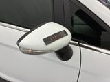 a white car with a clock on the side of it