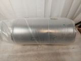 a large metal barrel wrapped in plastic on the floor