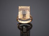 an 18k yellow gold ring set with an emerald stone