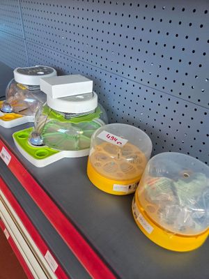 several containers of food sit on a shelf in a store