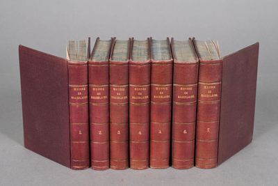 six red books are lined up in a row on a gray surface