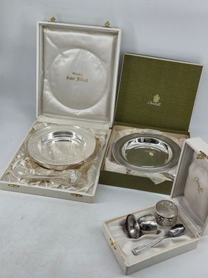 three silverplated dishes and spoons in a box on a white surface