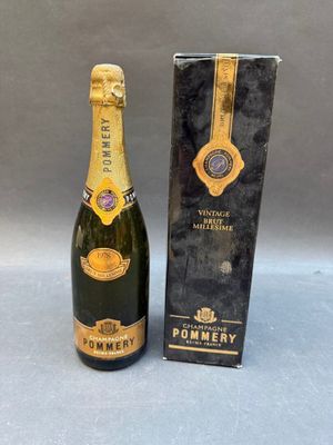 a bottle of champagne sitting next to a box of wine