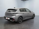 the rear end of a silver car in a white room