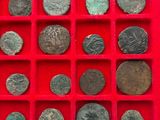 a red tray with a lot of old coins in it