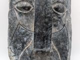 a stone sculpture of a man ' s face on a white background