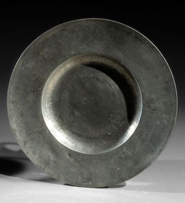 a silver plate sitting on top of a white table
