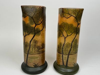 two vases that have been painted with trees on them