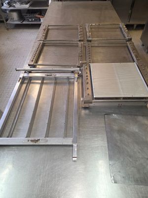a large metal table in the middle of a kitchen