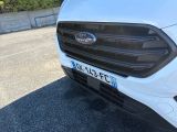 a close up of the front of a white ford transit vehicle