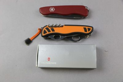 a swiss army knife and a swiss army knife on a table