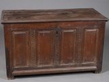 an old wooden chest with two doors and a drawer underneath it