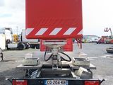 a red and white truck that is parked in a parking lot