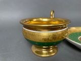 a gold and green bowl and a plate on a table