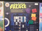 three board games sitting on a black surface, one of which is a monster and the other of which is a ghost