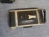 three old cameras sitting on a table next to each other