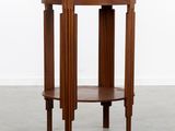 a round wooden table with three legs and a wooden top