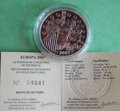 a picture of a piece of paper with a coin on it