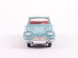 a small toy car that is sitting on a white surface