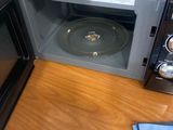 a microwave that is sitting on a table with a cd