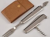three different types of knives and a wallet on the table