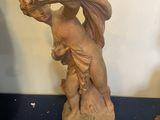 a statue of a woman carrying a bag on her head