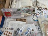 many different types of stamps and envelopes laid out on a table